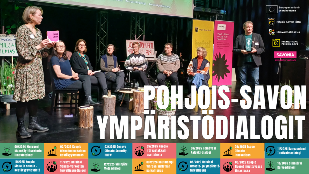 Kuvassa kuusi henkilöä istuu puolikaaressa tuoleilla ja kuuntelevat kahta henkilöä, jotka seisovat kaaren reunoilla.